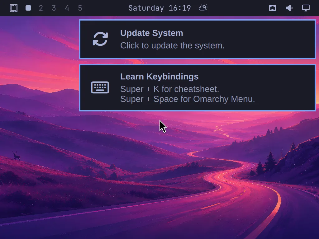 The Omarchy welcome overlay on first boot, prompting you to update the system and learn keybindings